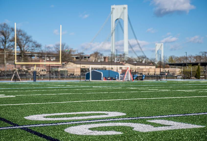 Football 50 yard line with bridge in backgroun